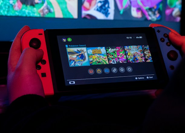 a person holding a nintendo wii game controller